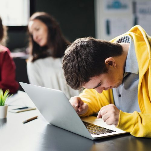 Down-syndrome man with laptop attending education, inclusivity of disabled person.